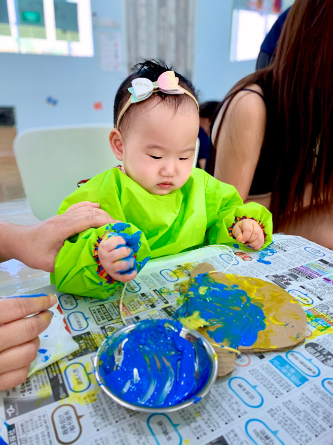 Baby exploring art and sensory play at a Mini Troopers class