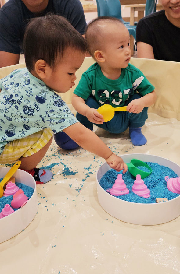 Toddler enjoying sensory play at a Little Troopers class